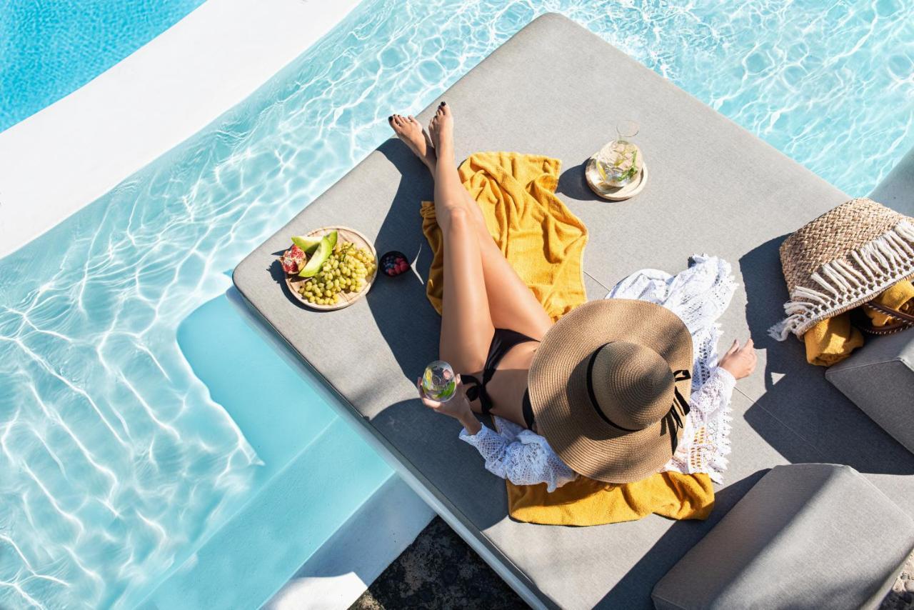 Santorini Kastelli Resort Kamari  Exterior photo A woman sunbathing